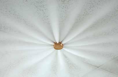 Copper-colored fire sprinkler system spraying jets of water