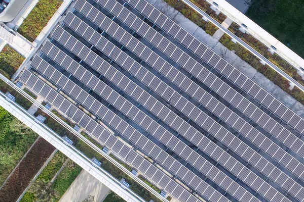 Top angle shot of a building with solar panels installed on the terrace