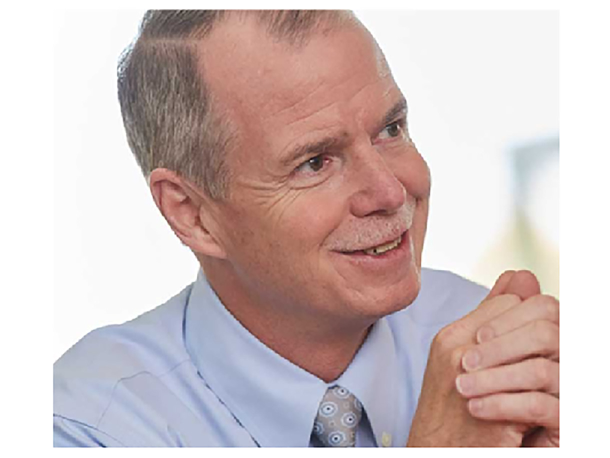 George Oliver, chairman and CEO of Johnson Controls, smiling during an interview