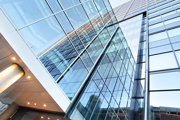 Upwards view of the exteriors of a tall glass building
