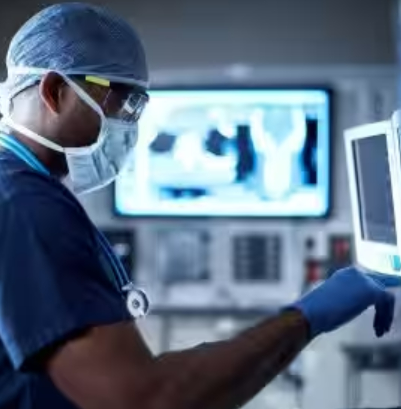 A doctor in scrubs examining medical equipment in an operation theater
