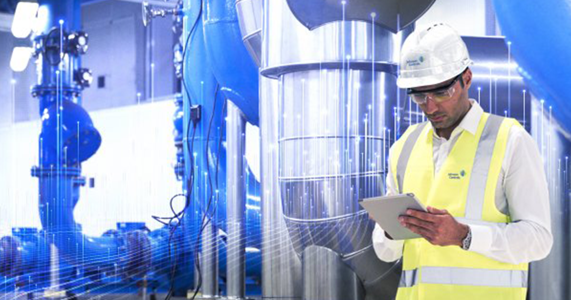 Johnson Controls technician using a tablet and inspecting HVAC equipments