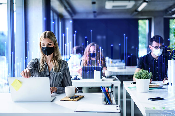 Employees wearing mask and working in office