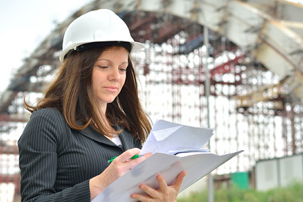 Farrell Boser, Project Manager at Johnson Controls, examining documents at a facility