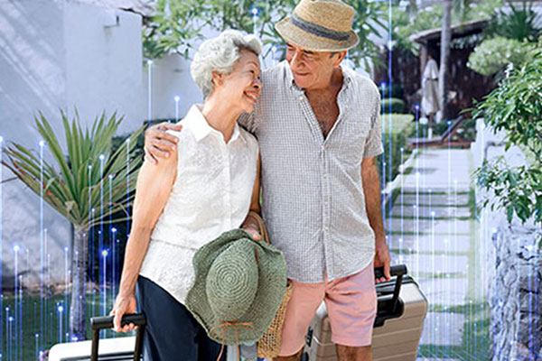 A couple walking together while dragging suitcases behind them