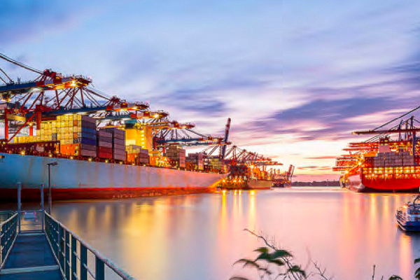 Container cargo ships in shipyard at dusk